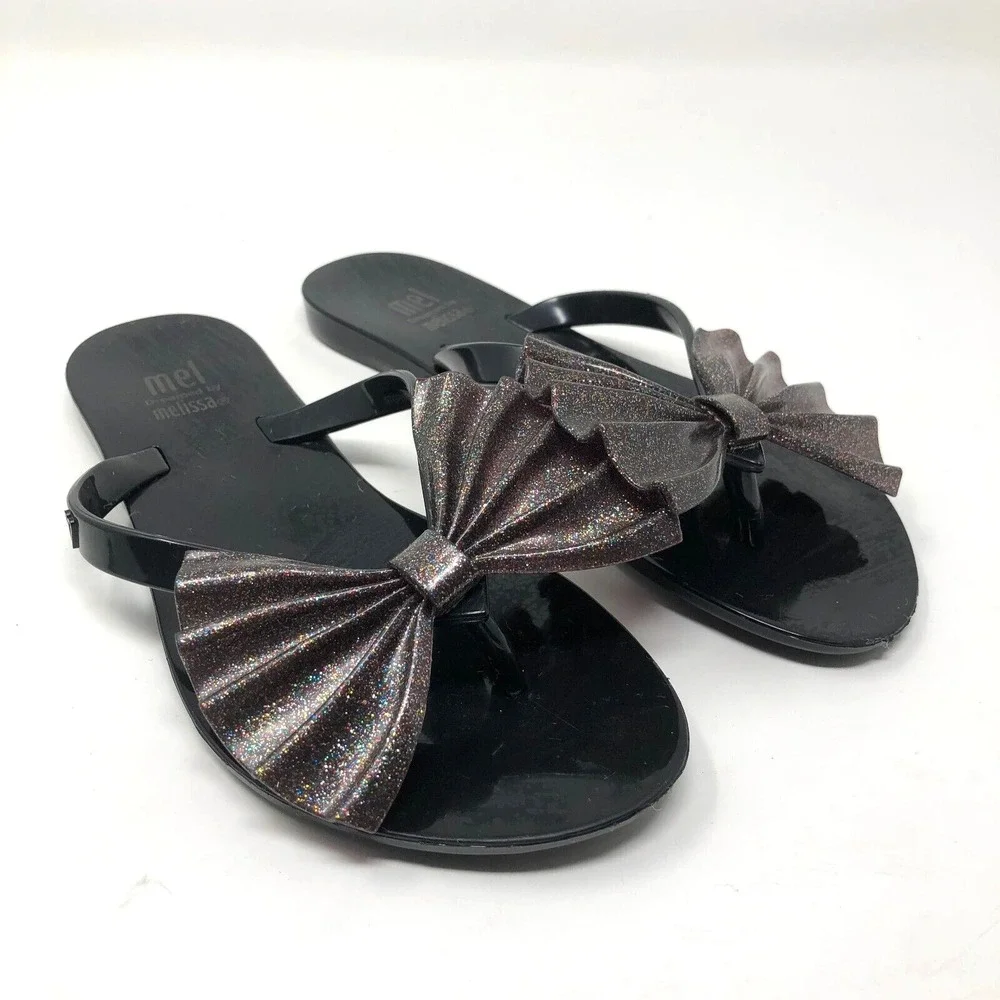 Melissa Mel Harmonic Bow Vi INF Flip Flops Girls 1 Black Glitter Scented